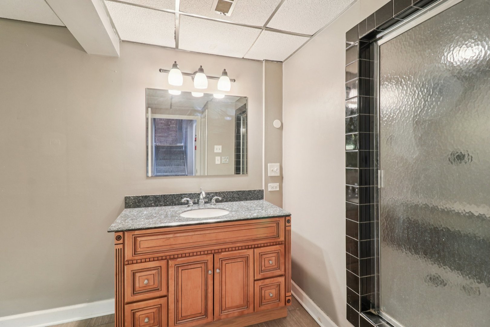 75 Mineola Road, Unit 75 Fox Lake, IL 60020 - Photo 26 of 33 a bathroom with a sink vanity and a mirror