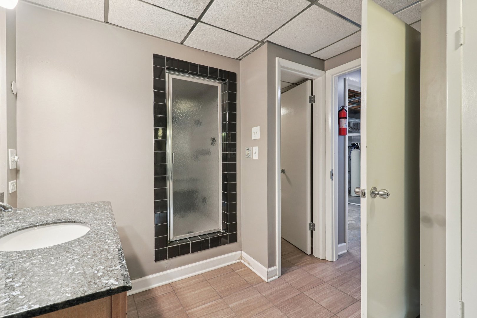 75 Mineola Road, Unit 75 Fox Lake, IL 60020 - Photo 29 of 33 a bathroom with a granite countertop shower a mirror and a sink