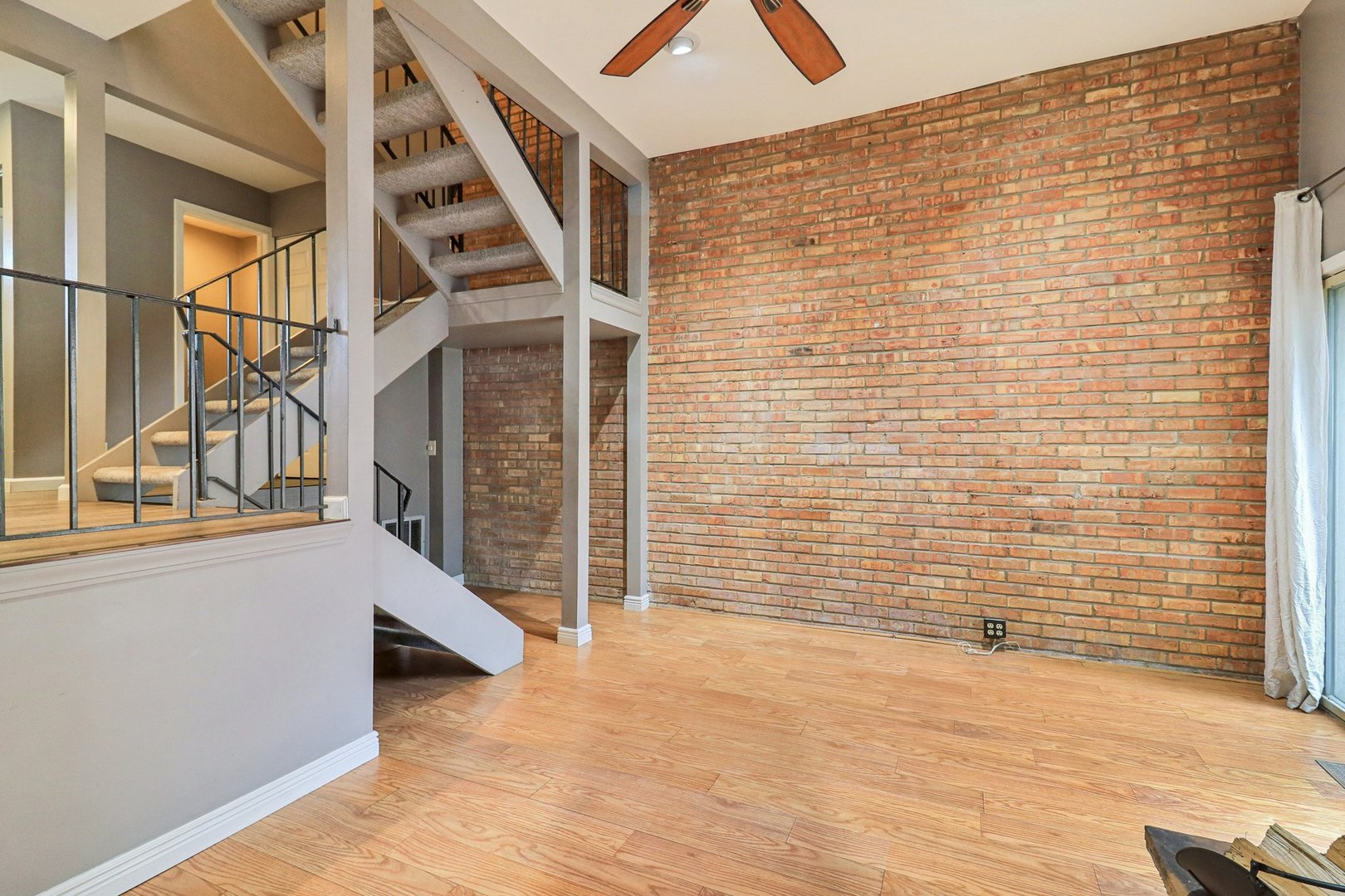 75 Mineola Road, Unit 75 Fox Lake, IL 60020 - Photo 5 of 33 a view of an empty room with wooden floor and a window
