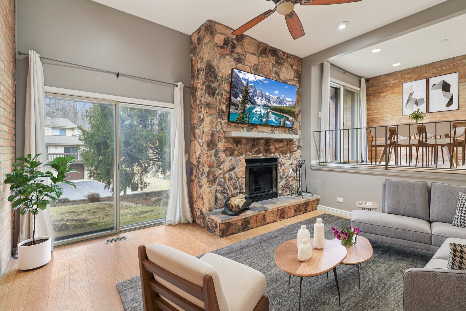 75 Mineola Road, Unit 75 Fox Lake, IL 60020 - Photo 6 of 33 a living room with furniture a flat screen tv and a fireplace