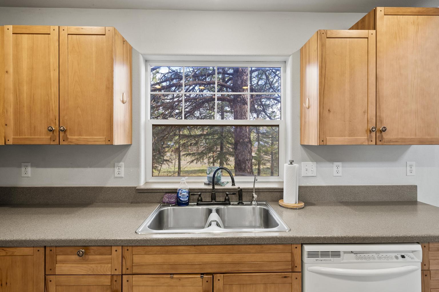 1190 Cedar Flat Road Williams, OR 97544 - Photo 9 of 45 a kitchen with stainless steel appliances a sink a window and cabinets