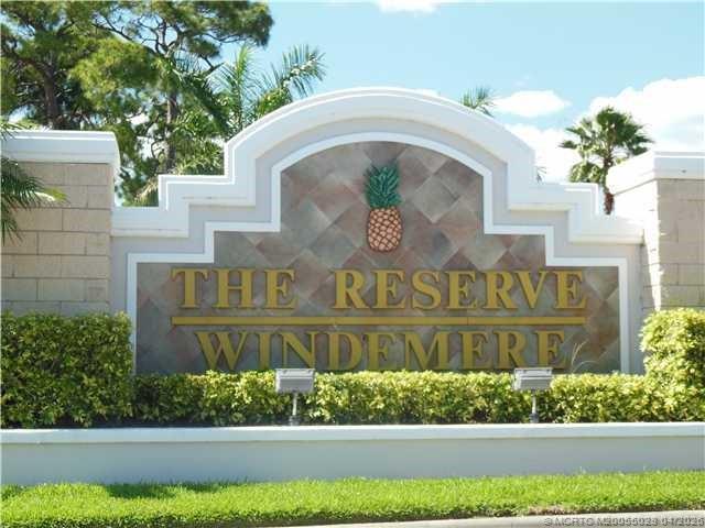 2120 Northwest Marsh Rabbit Lane Jensen Beach, FL 34957 - Photo 1 of 34 a front of a house with a yard and potted plants