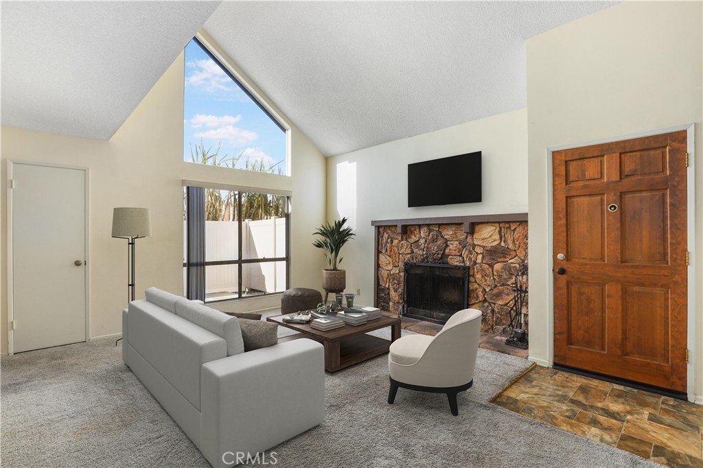 a living room with furniture and a fireplace