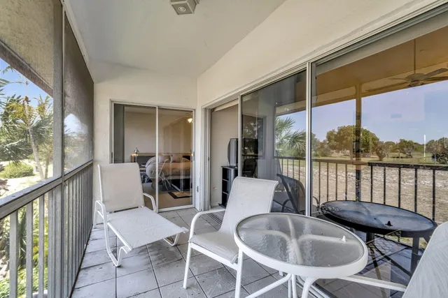 a dining room with furniture and large windows
