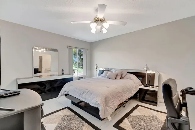 a bedroom with a bed a table and chair