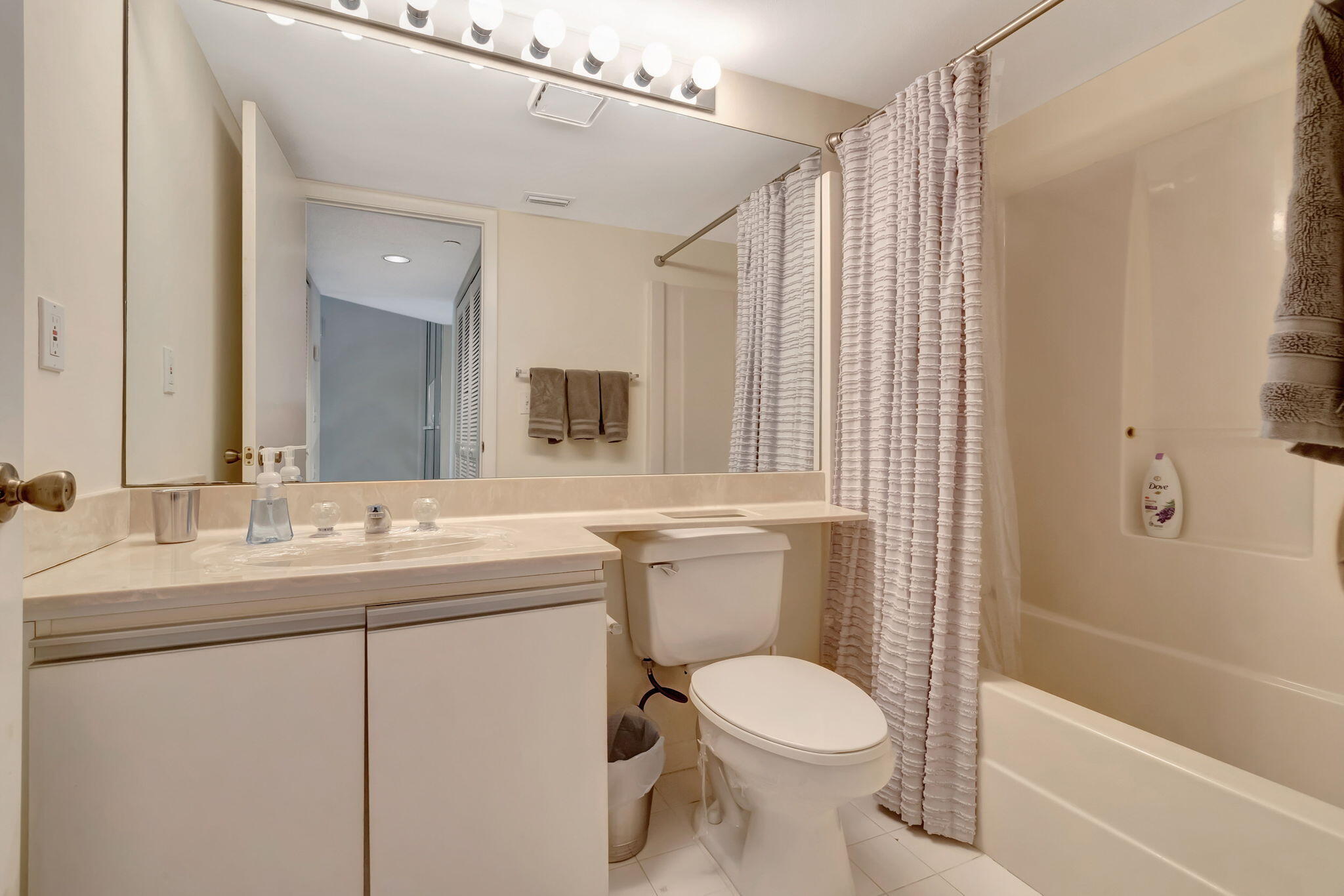 280 Northwest 67th Street, Unit B 207 Boca Raton, FL 33487 - Photo 9 of 13 a bathroom with a sink a toilet and shower