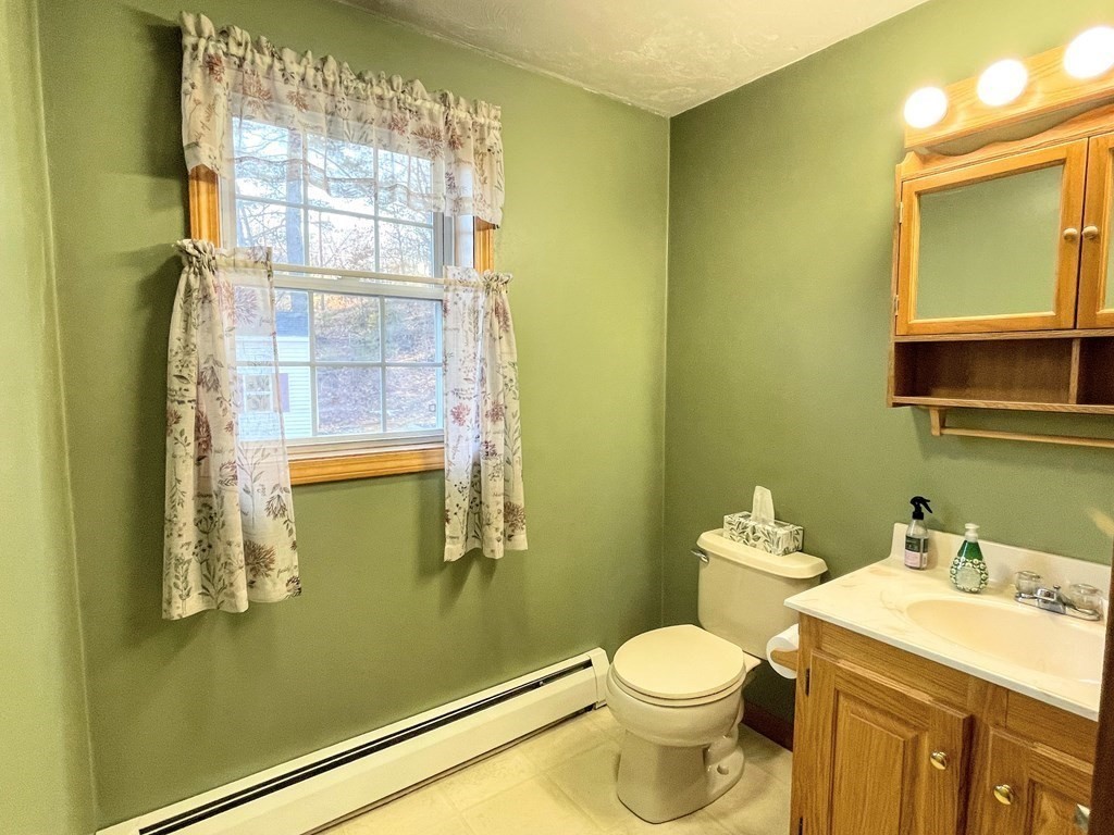 14 Mt Henry Road Shirley, MA 01464 - Photo 9 of 29 a bathroom with a toilet sink and mirror