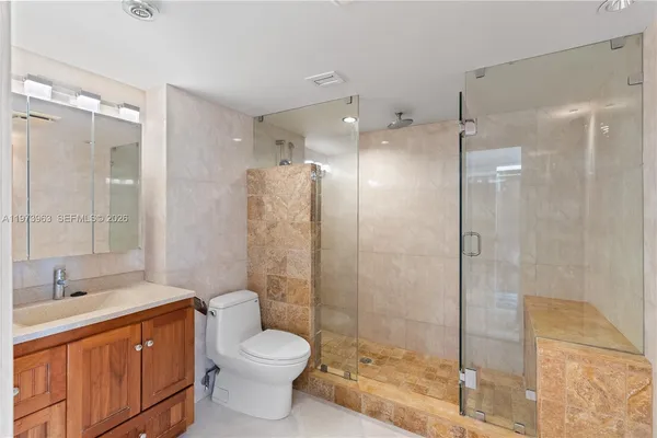 a bathroom with a double vanity sink toilet and shower