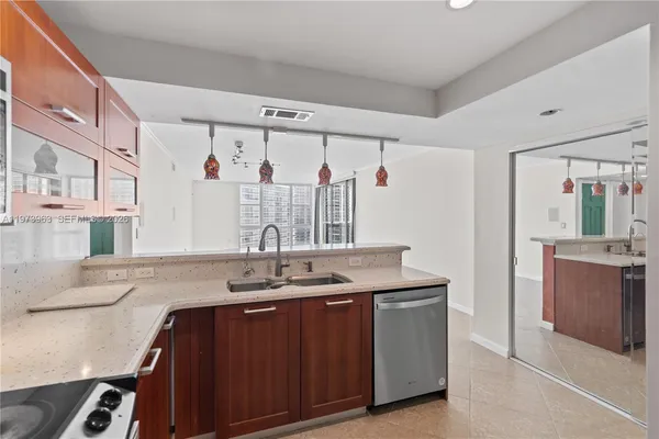 a bathroom with a granite countertop sink a mirror and a shower