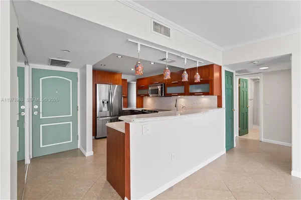 a view of kitchen with stainless steel appliances granite countertop cabinets and a refrigerator