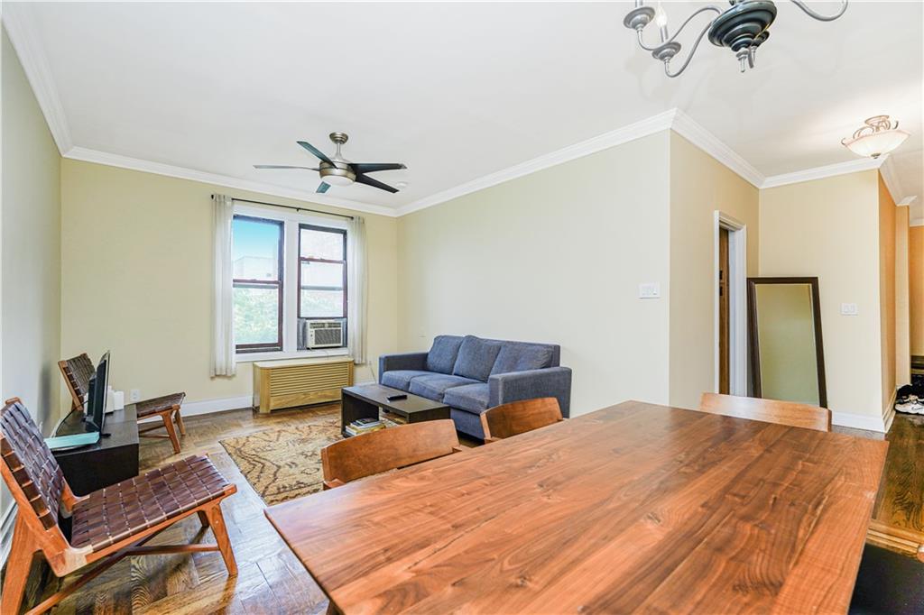 351 Marine Avenue, Unit F11 Brooklyn, NY 11209 - Photo 4 of 23 a bedroom with a bed a couch and a window