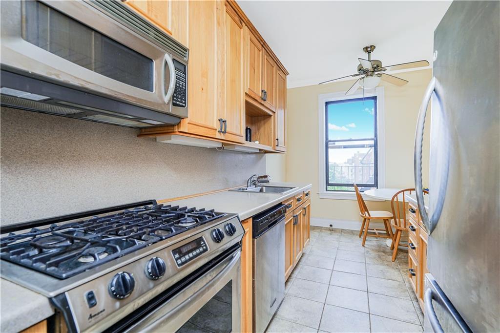 351 Marine Avenue, Unit F11 Brooklyn, NY 11209 - Photo 6 of 23 a kitchen with stainless steel appliances a stove a sink and a microwave