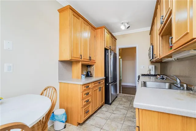 a kitchen with stainless steel appliances granite countertop a sink a stove and a refrigerator