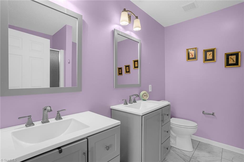2786 WaterStone Loop High Point, NC 27265 - Photo 18 of 30 Primary Bath was recently updated with new sinks/vanities, toilet, flooring, and fixtures.