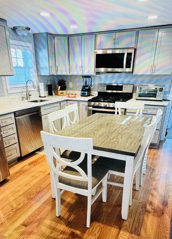 34 Soundview Road Centerville, MA 02632 - Photo 8 of 15 a kitchen with stainless steel appliances kitchen island granite countertop a stove a sink a microwave and a refrigerator