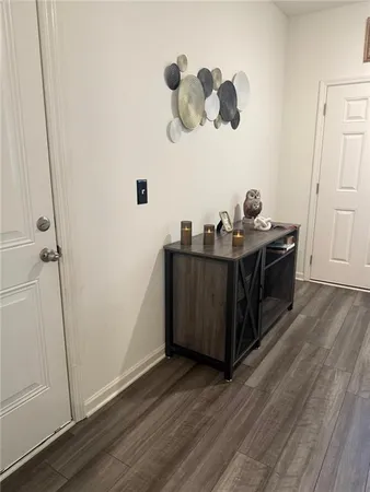 a view of a room with wooden floor