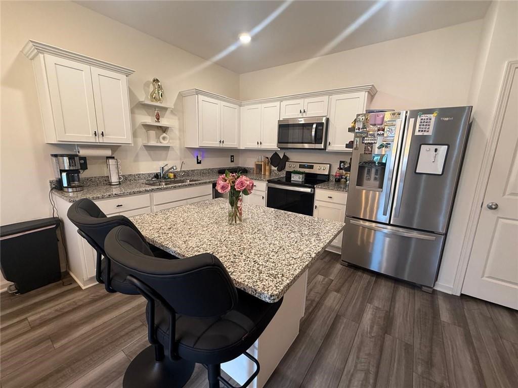 59 Thetford Way Winder, GA 30680 - Photo 5 of 13 a kitchen with stainless steel appliances granite countertop a refrigerator stove microwave and sink