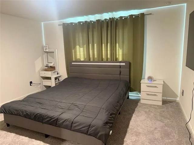 a bedroom with a bed and window