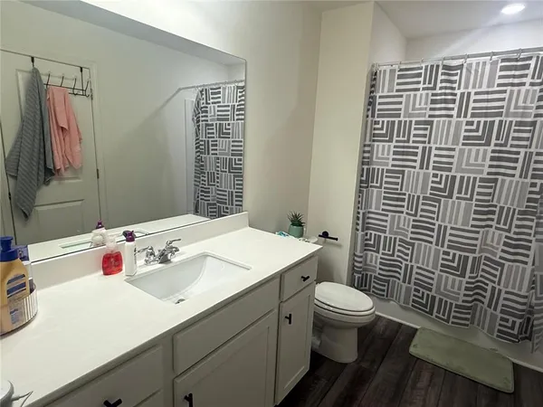 a bathroom with a sink toilet and shower