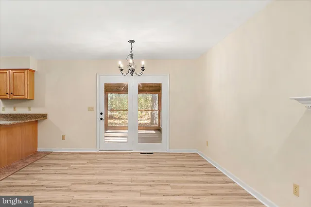 a kitchen with stainless steel appliances granite countertop a sink a stove a microwave a refrigerator a counter space and cabinets