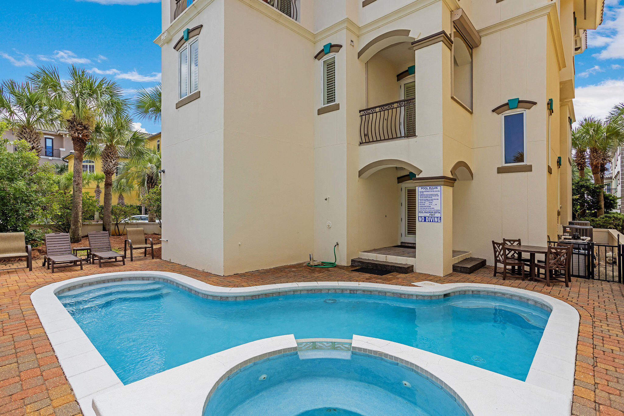 4713 Ocean Boulevard Destin, FL 32541 - Photo 5 of 90 a backyard of a house with table and chairs