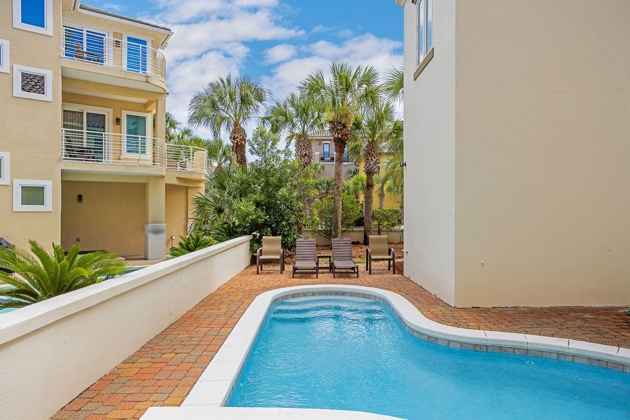 4713 Ocean Boulevard Destin, FL 32541 - Photo 87 of 90 a view of a swimming pool with a bench and potted plants