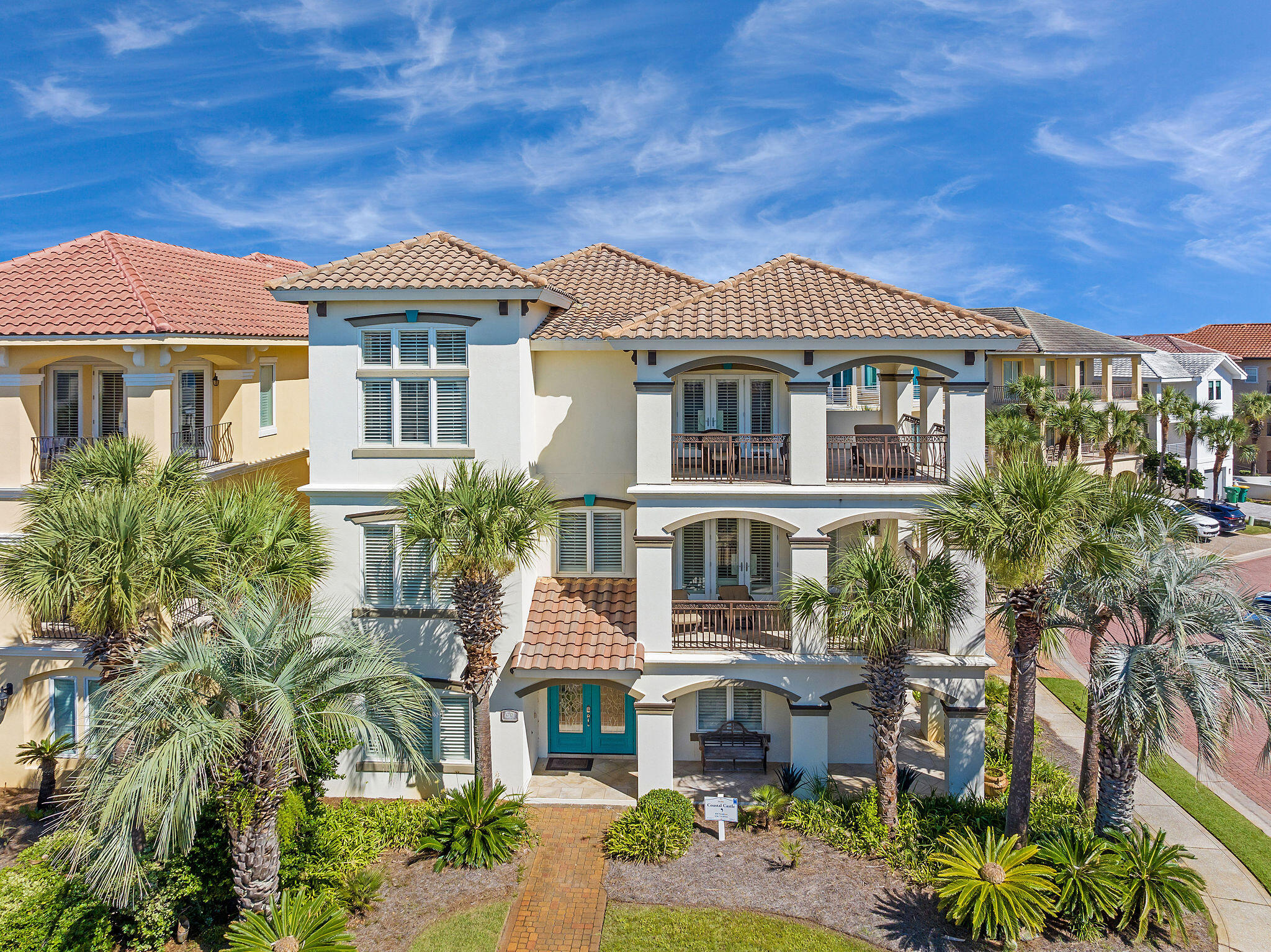 4713 Ocean Boulevard Destin, FL 32541 - Photo 90 of 90 a front view of a residential apartment building with a yard