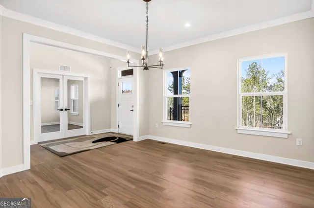 a view of livingroom with hardwood floor and kitchen