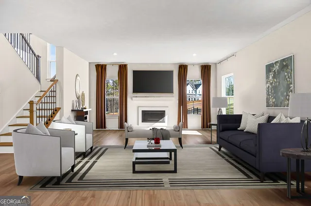 a view of an empty room with wooden floor fireplace and a window