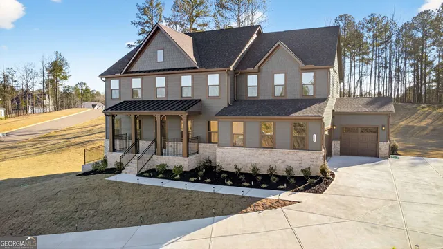 a front view of a house with a yard and garage