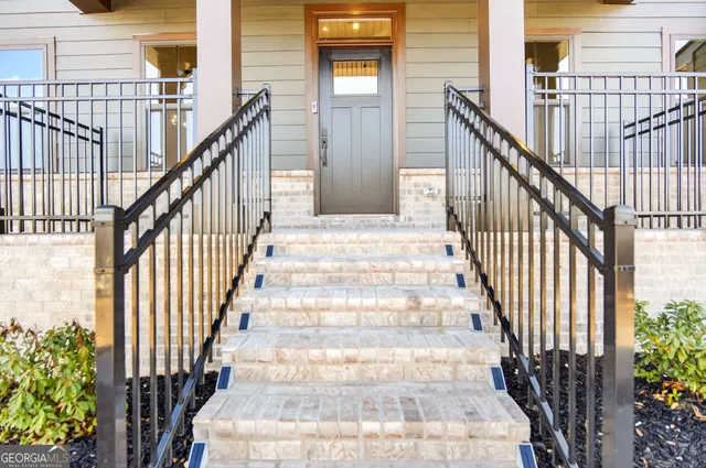 a view of entryway with wooden floor and stairs