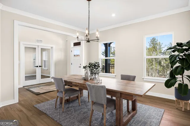 a view of empty room with wooden floor and ceiling fan
