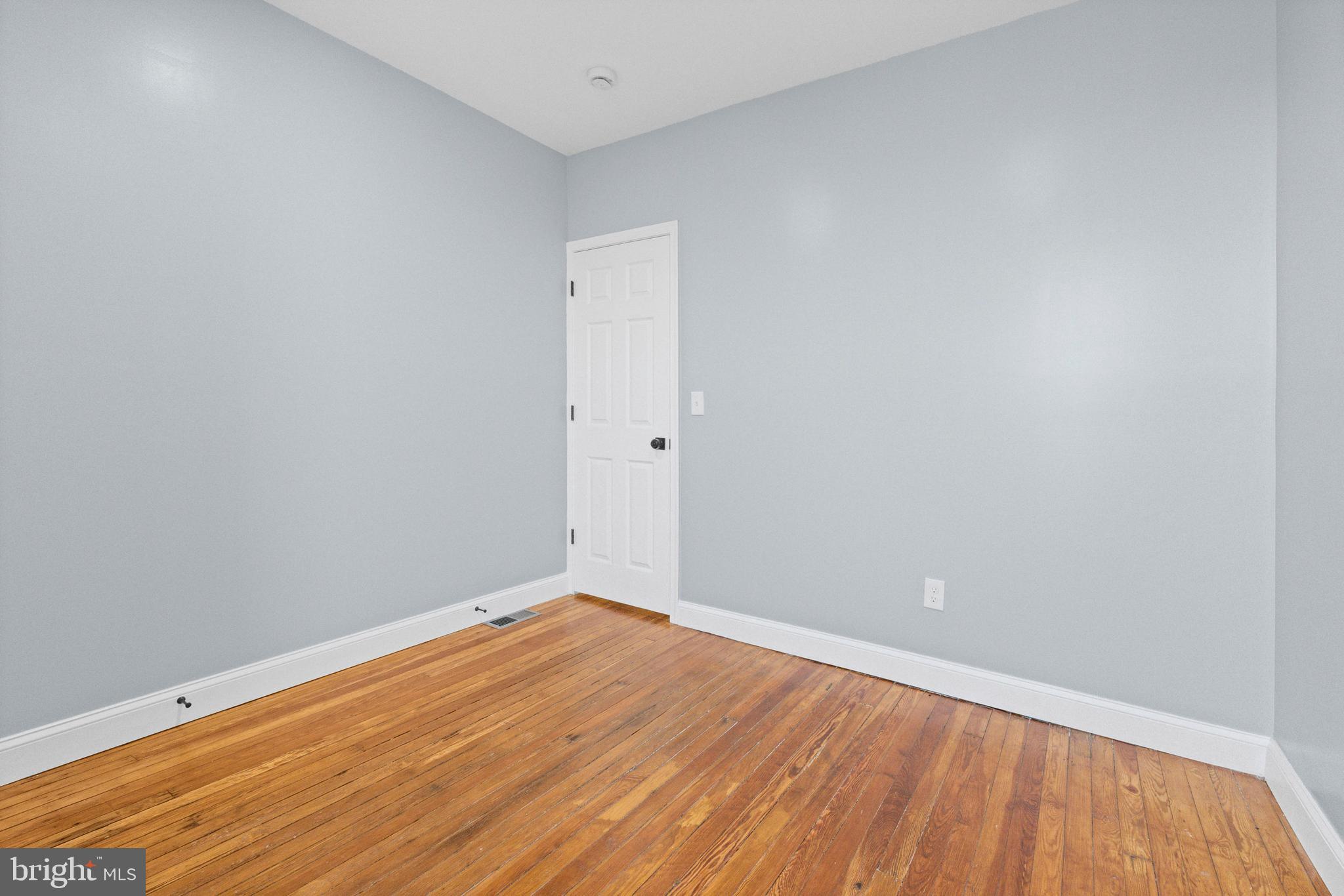 2806 Riggs Avenue Baltimore, MD 21216 - Photo 16 of 32 a view of an empty room with wooden floor