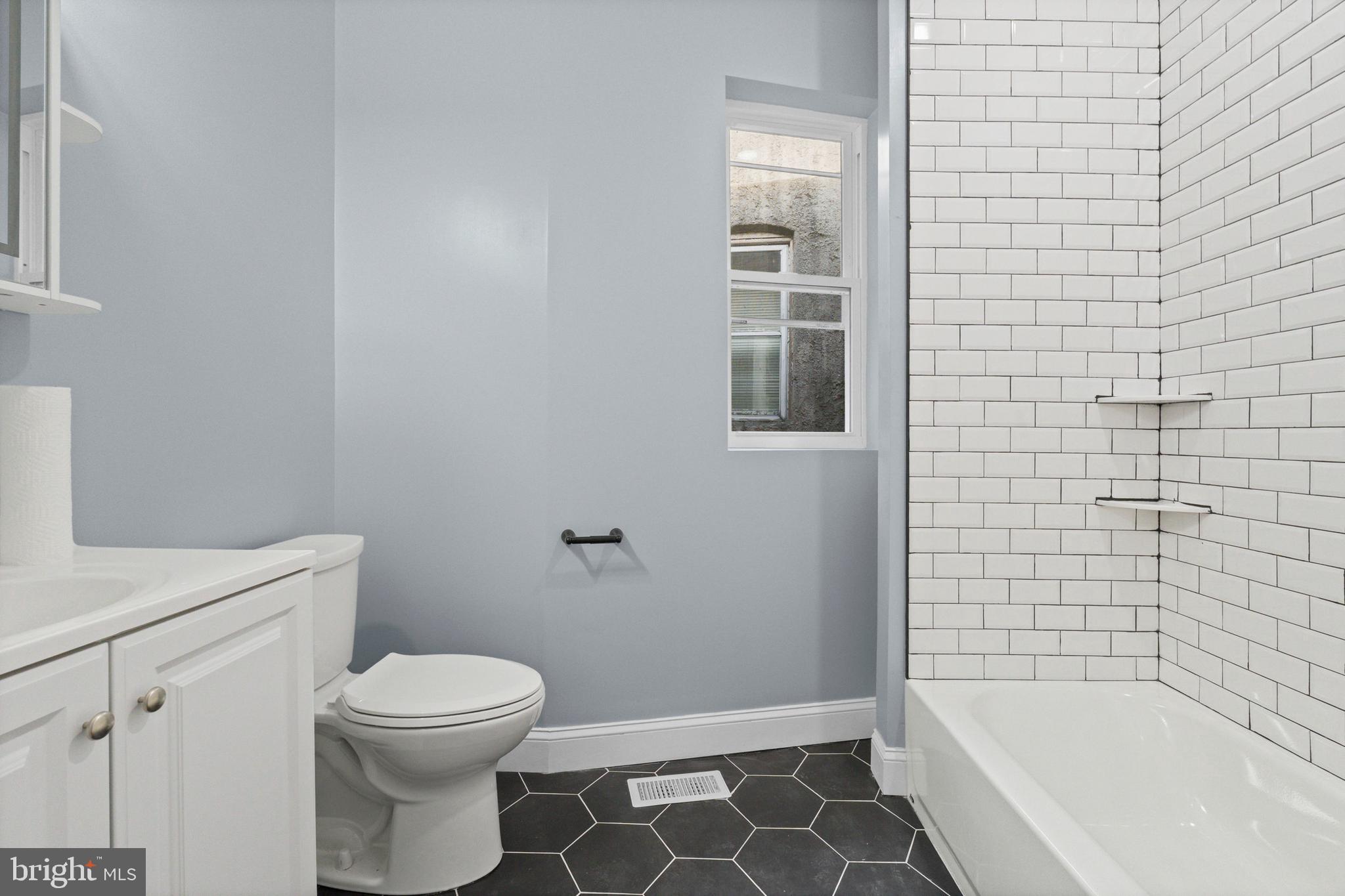 2806 Riggs Avenue Baltimore, MD 21216 - Photo 19 of 32 a bathroom with a toilet and shower