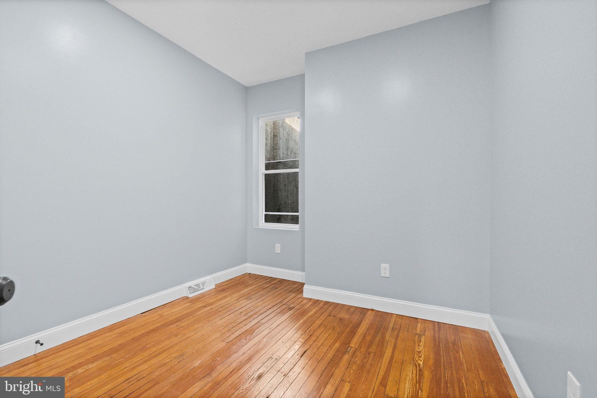 2806 Riggs Avenue Baltimore, MD 21216 - Photo 21 of 32 a view of empty room with wooden floor