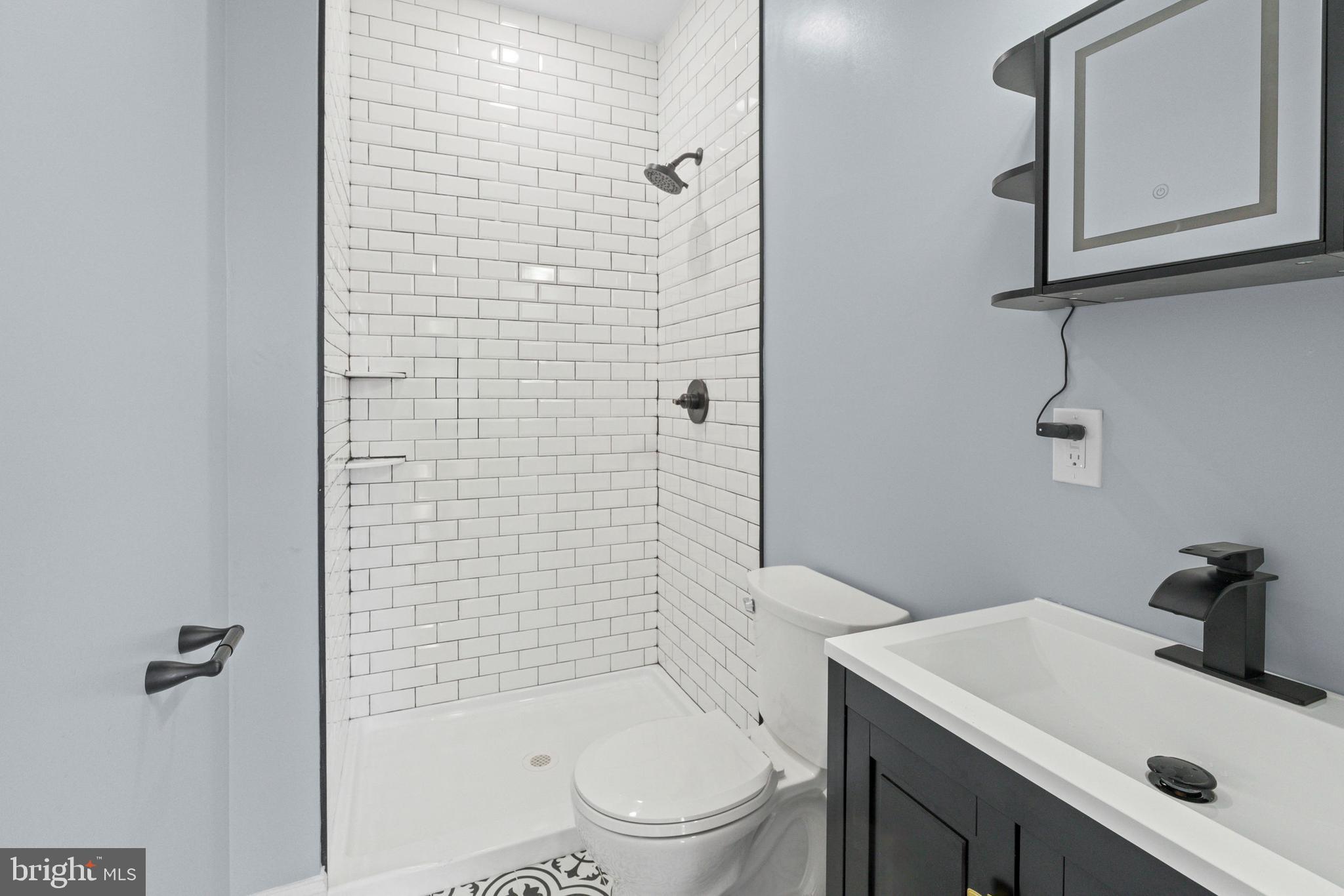 2806 Riggs Avenue Baltimore, MD 21216 - Photo 24 of 32 a bathroom with a sink a toilet and shower