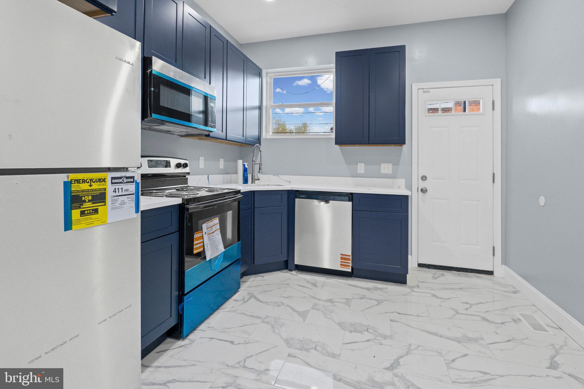 2806 Riggs Avenue Baltimore, MD 21216 - Photo 28 of 32 a kitchen with stainless steel appliances granite countertop a stove a sink and a refrigerator