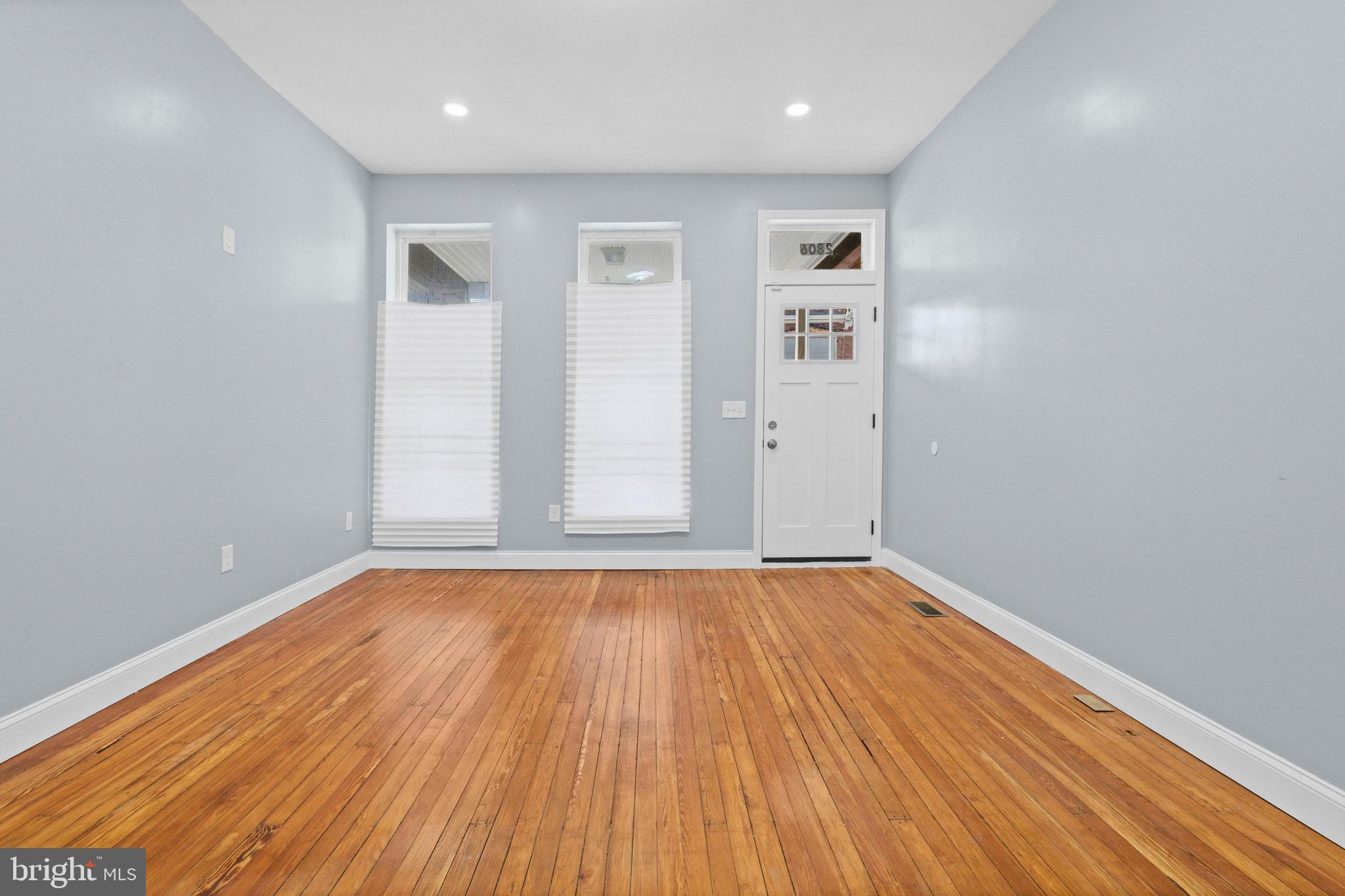 2806 Riggs Avenue Baltimore, MD 21216 - Photo 32 of 32 a view of an empty room with wooden floor and a window