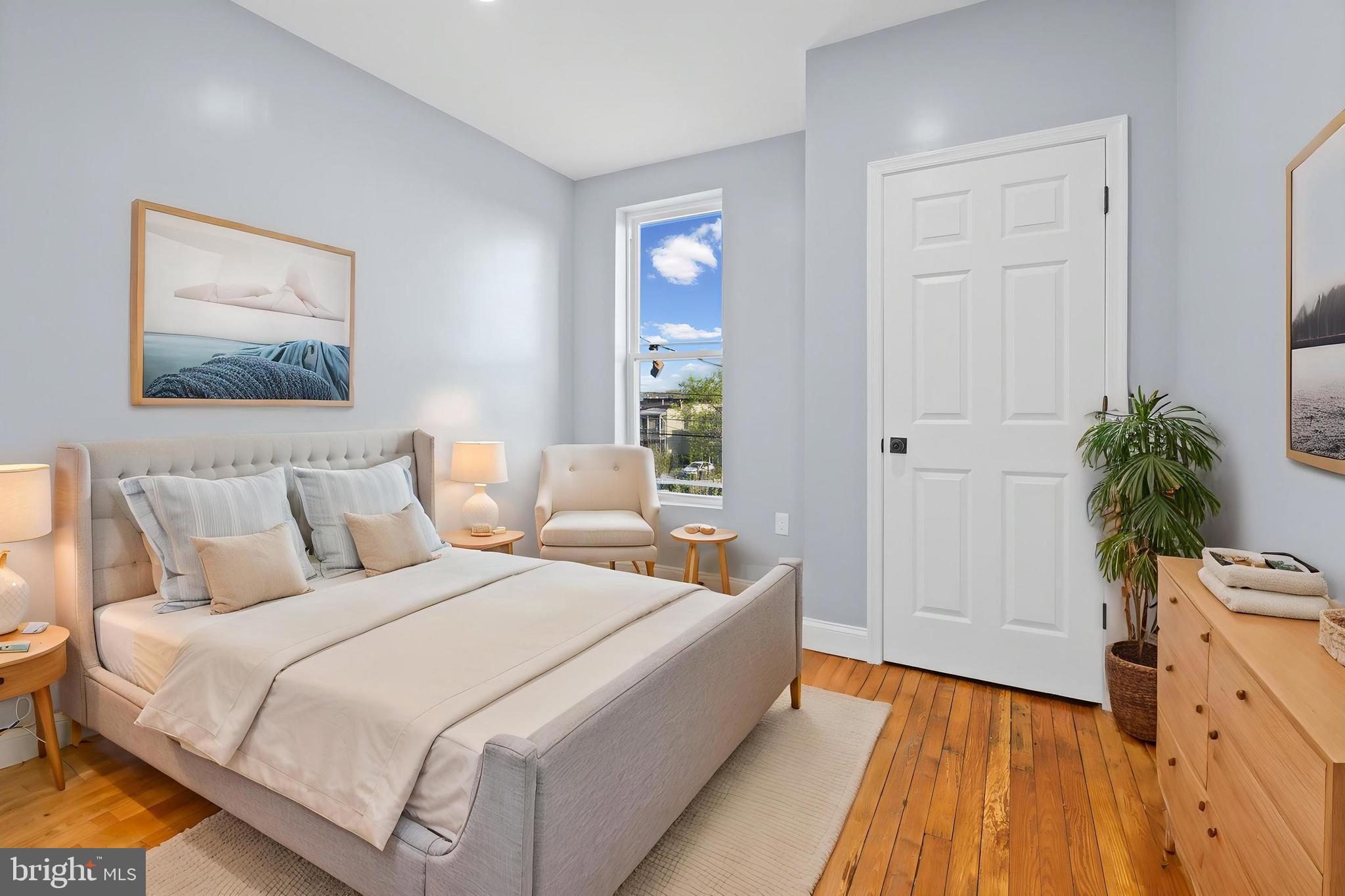 2806 Riggs Avenue Baltimore, MD 21216 - Photo 6 of 32 a bed room with a bed and a potted plant