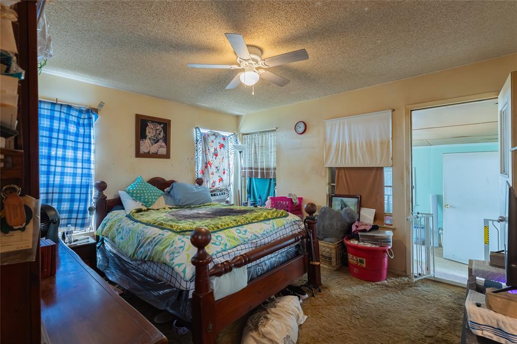 6473 West Highway 199 Springtown, TX 76082 - Photo 15 of 40 Carpeted bedroom featuring a textured ceiling and ceiling fan