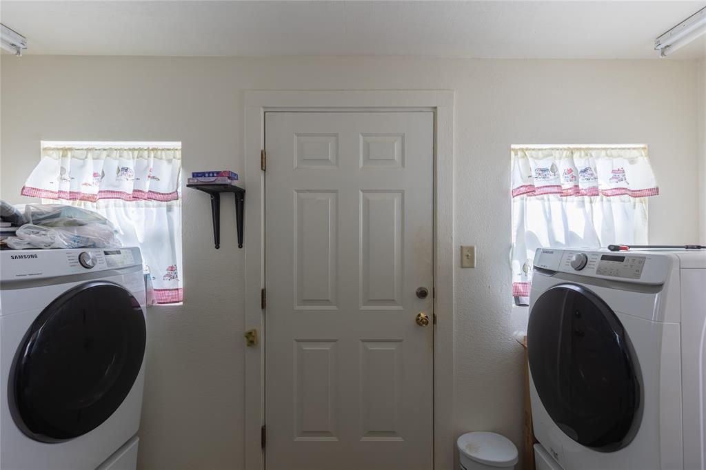 6473 West Highway 199 Springtown, TX 76082 - Photo 19 of 40 Laundry room with washer / dryer and track lighting
