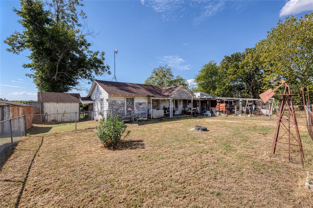 6473 West Highway 199 Springtown, TX 76082 - Photo 21 of 40 view of property featuring a fenced backyard and an outbuilding