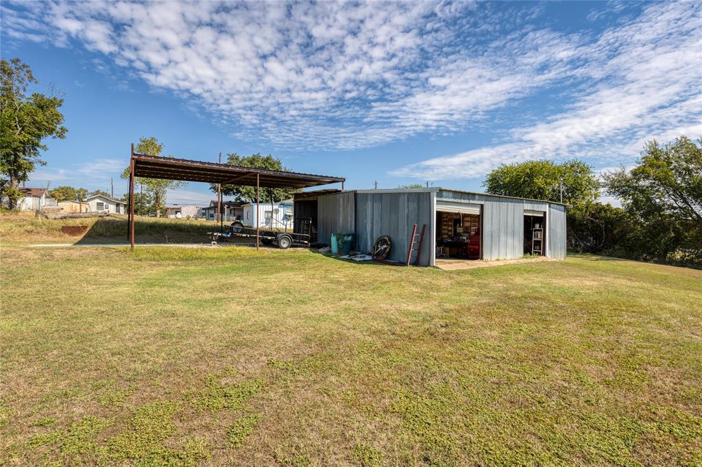 6473 West Highway 199 Springtown, TX 76082 - Photo 27 of 40 View of pole building featuring a yard