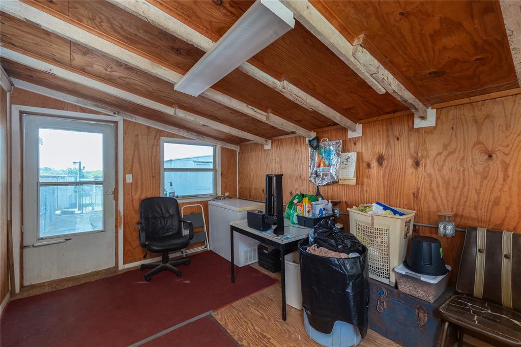 6473 West Highway 199 Springtown, TX 76082 - Photo 5 of 40 Home office featuring wood walls, wood finished floors, and a wooden ceiling with exposed beams
