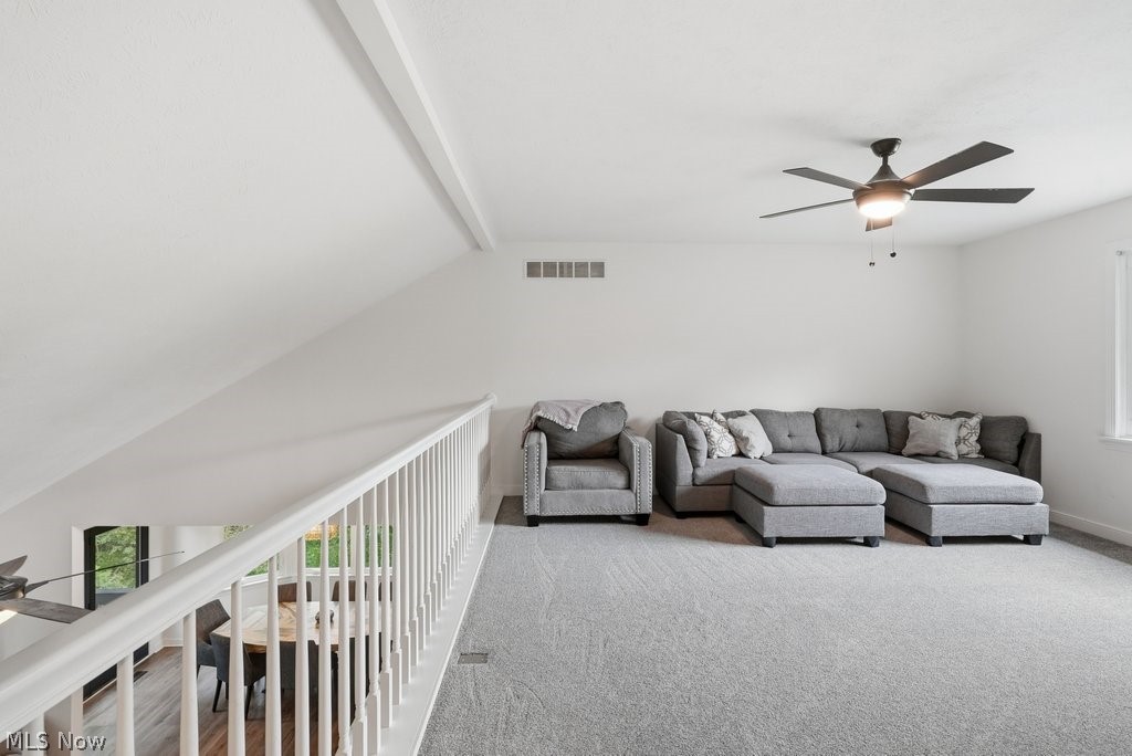 2323 Call Road Stow, OH 44224 - Photo 26 of 42 Carpeted loft space featuring a contemporary ceiling fan, white railings, and a sloped ceiling