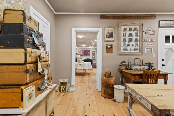 a living room with furniture and paintings on the wall