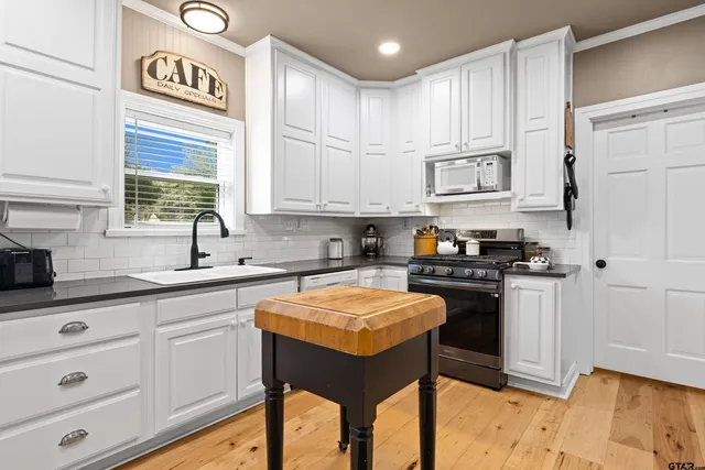 a view of a livingroom with furniture and staircase