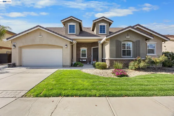 a front view of house with yard and green space