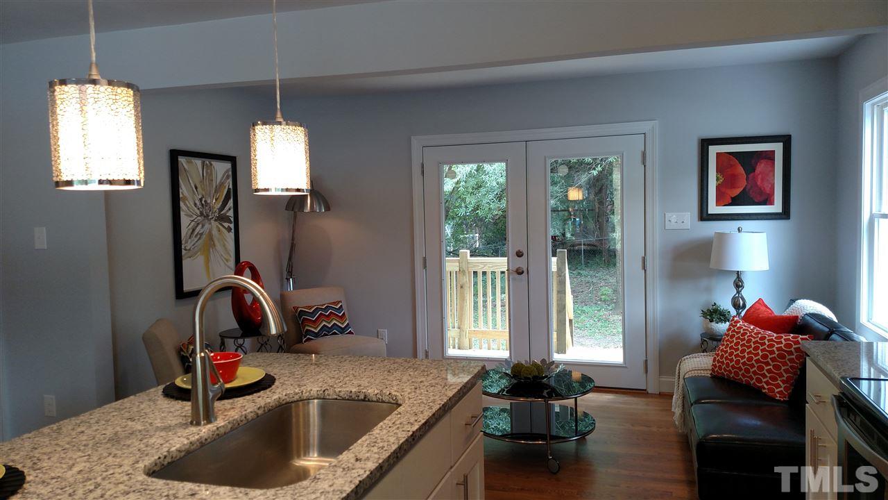 2318 Kennington Road Raleigh, NC 27610 - Photo 3 of 20 a kitchen with a sink refrigerator and window