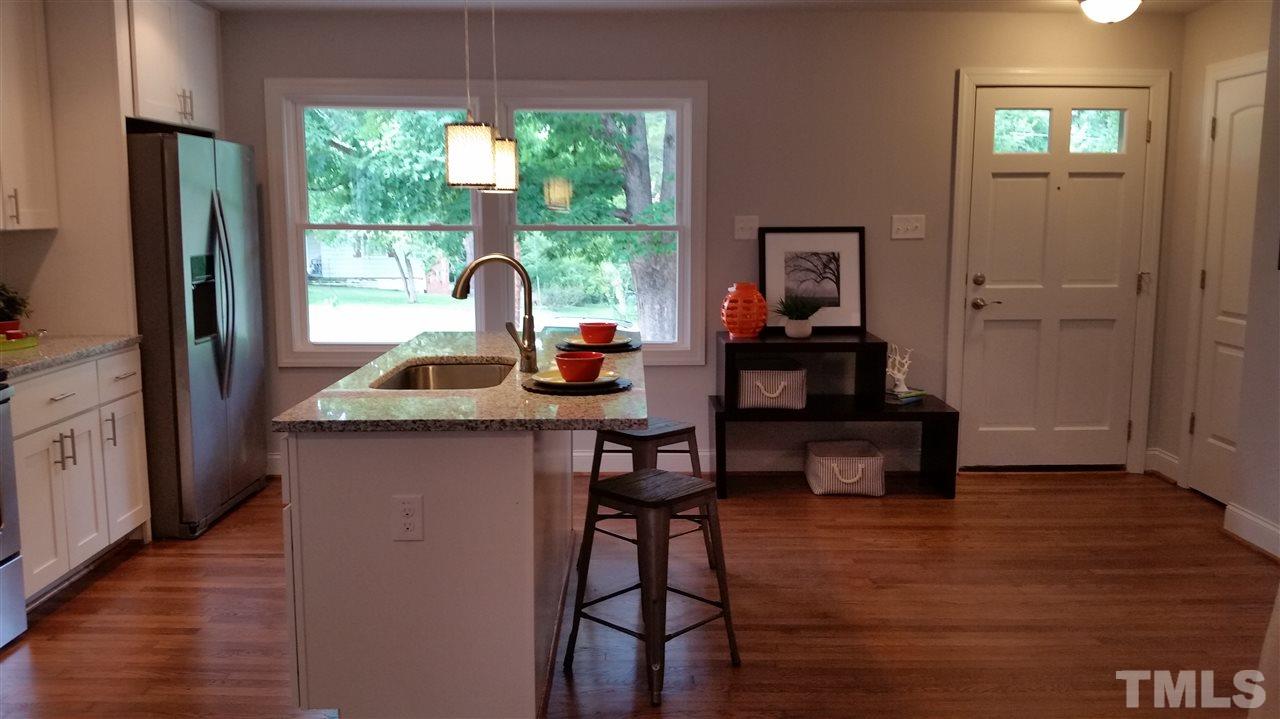 2318 Kennington Road Raleigh, NC 27610 - Photo 7 of 20 a work room with wooden floor and a window